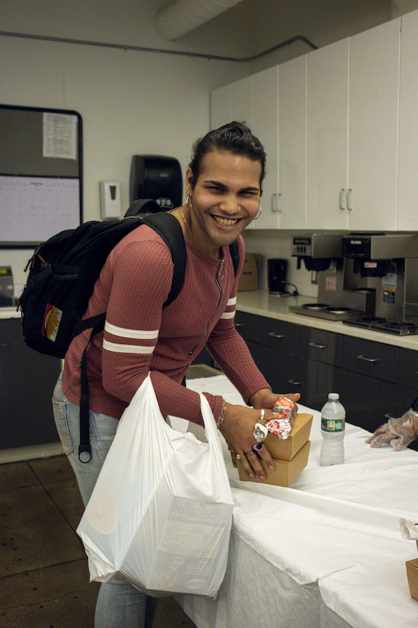 A person receiving donated food from Rescuing Leftover Cuisine