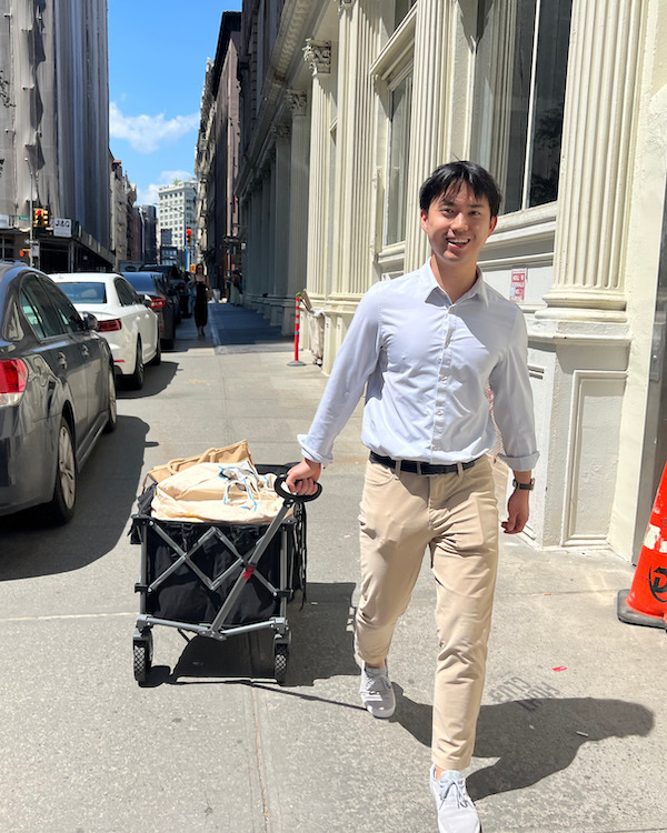 A volunteer carrying bags of donated food